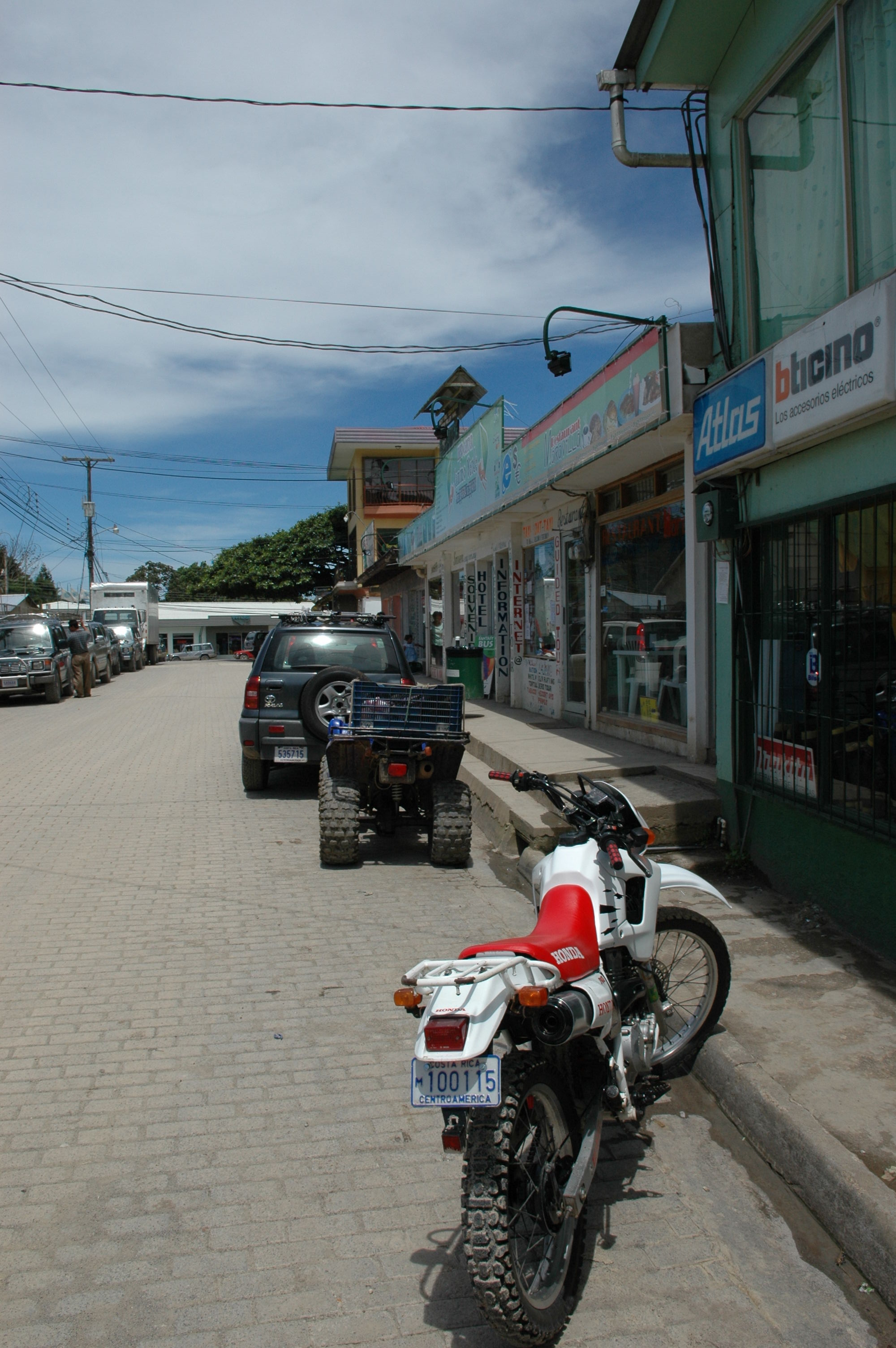 Downtown Santa Elena, close to the Monteverde Cloud Forest.  In the foreground you can see the preferred method of transport, the dirtbike.  Note the large shock absorbers and knobby tires.